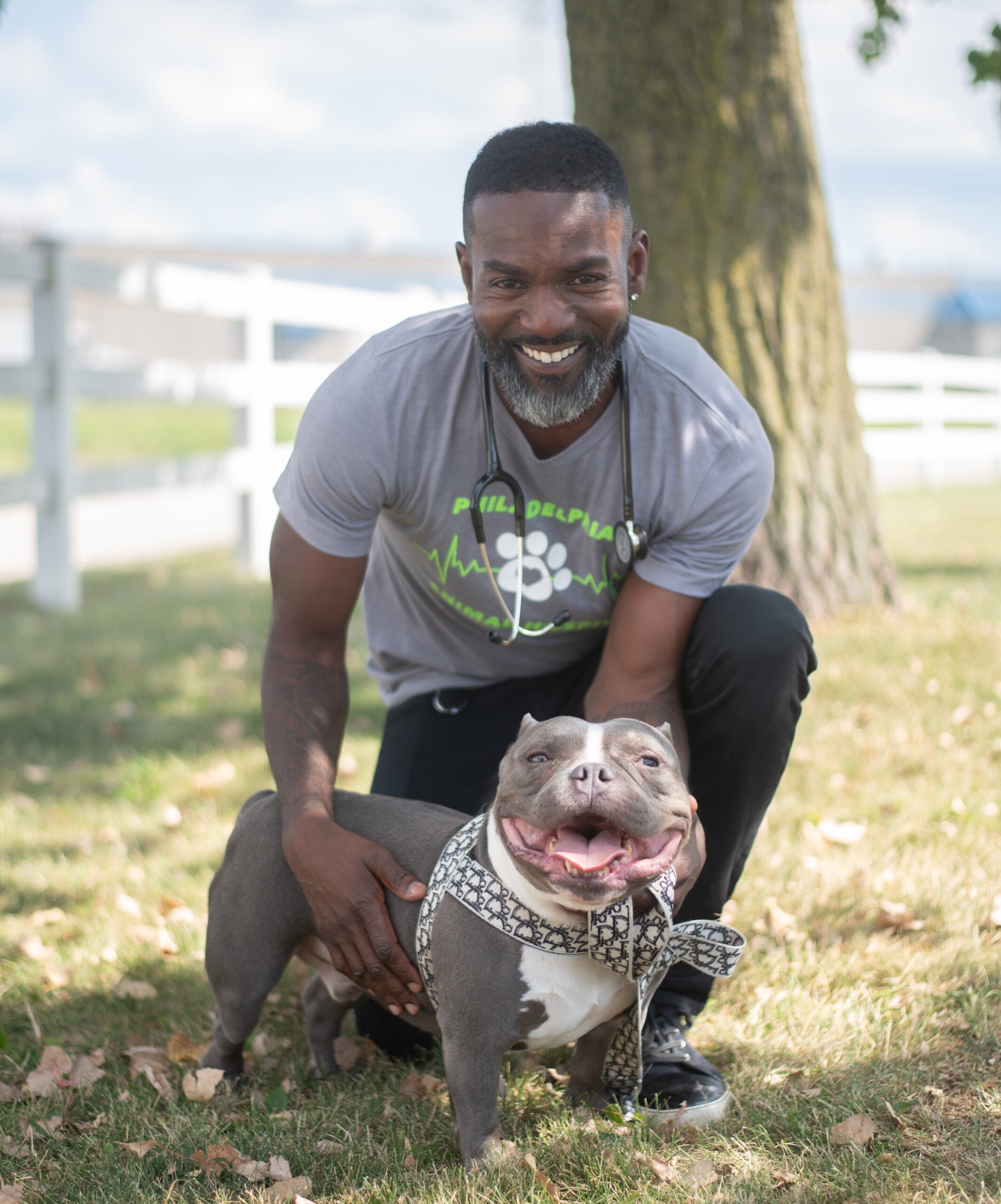 Dr. Kipp Chapman holding his grey pitbull Lando outside Philadelphia Animal Hospital